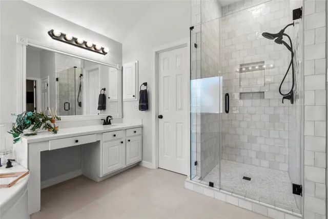a bathroom with a double vanity sink mirror and shower