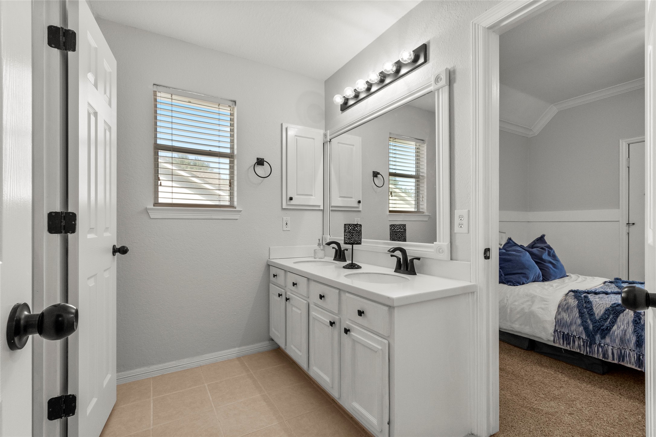 9114 Kirkstone Drive Spring, TX 77379 - Photo 24 of 31 a en suite bathroom with 2 sink and a mirror