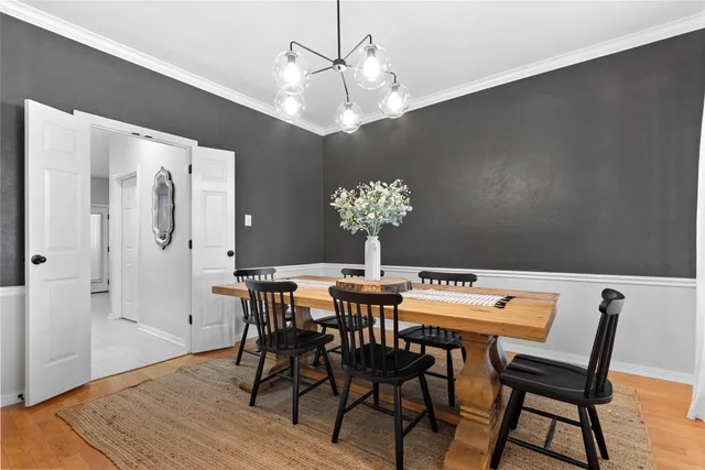 a view of a dining room with furniture and chandelier