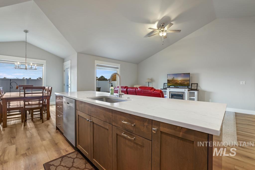 4073 Williams Street Buhl, ID 83316 - Photo 31 of 31 Kitchen with lofted ceiling, pendant lighting, an island with sink, open floor plan, and light wood-type flooring