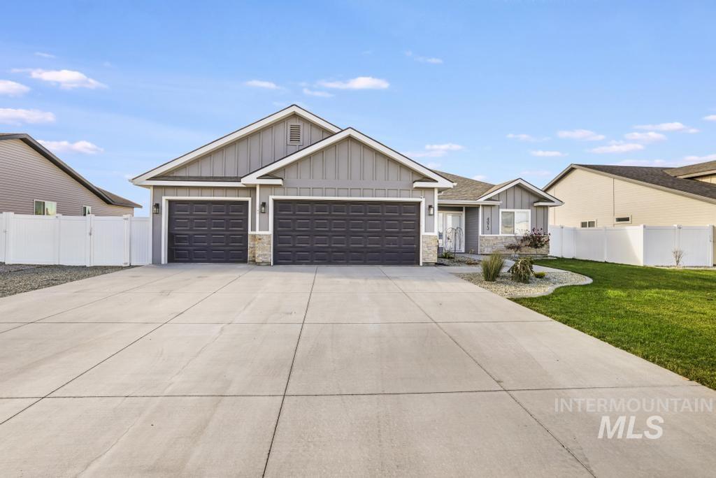 4073 Williams Street Buhl, ID 83316 - Photo 2 of 31 View of front of home featuring board and batten siding, stone siding, driveway, and a garage