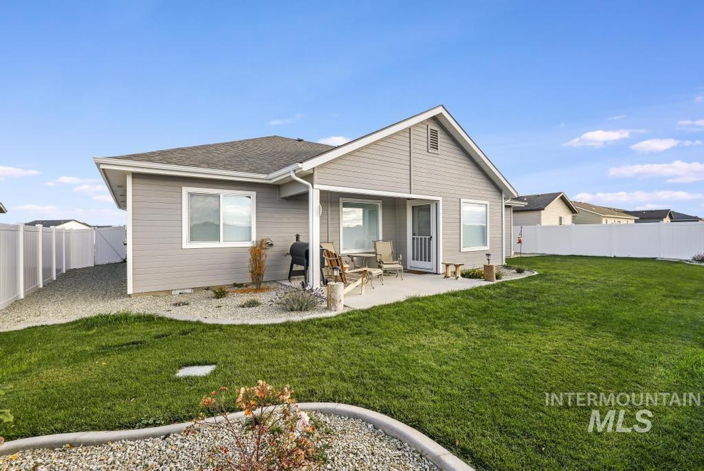 4073 Williams Street Buhl, ID 83316 - Photo 28 of 31 Rear view of property with a fenced backyard, a patio area, and roof with shingles