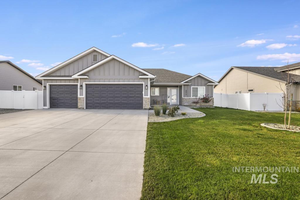 4073 Williams Street Buhl, ID 83316 - Photo 3 of 31 View of front of home featuring board and batten siding, an attached garage, concrete driveway, and stone siding