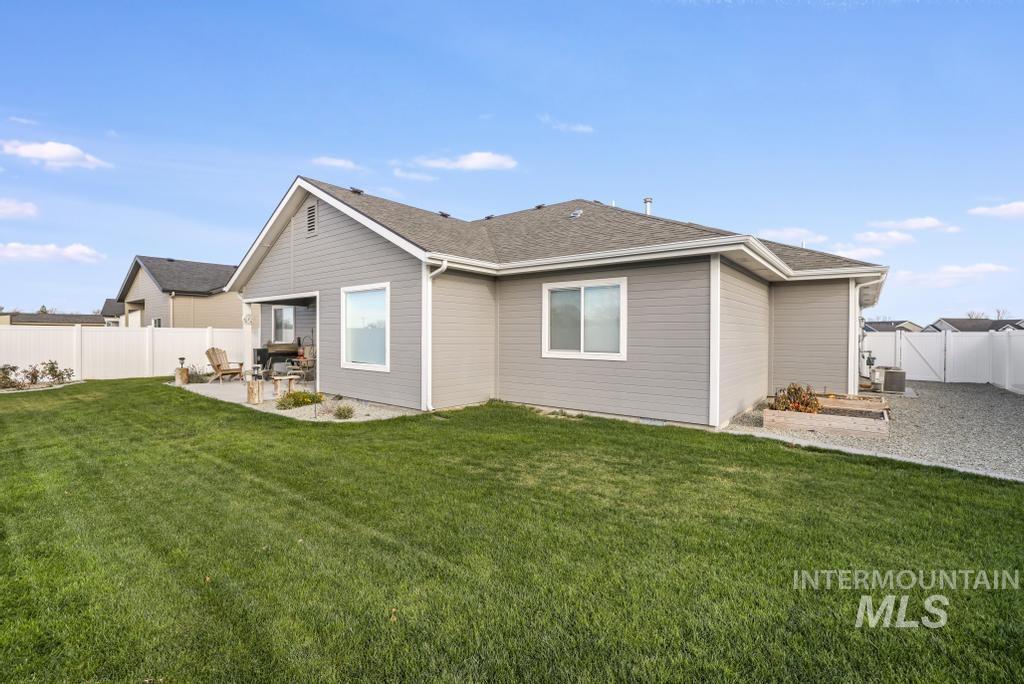 4073 Williams Street Buhl, ID 83316 - Photo 30 of 31 Back of property with a fenced backyard, a patio, and roof with shingles