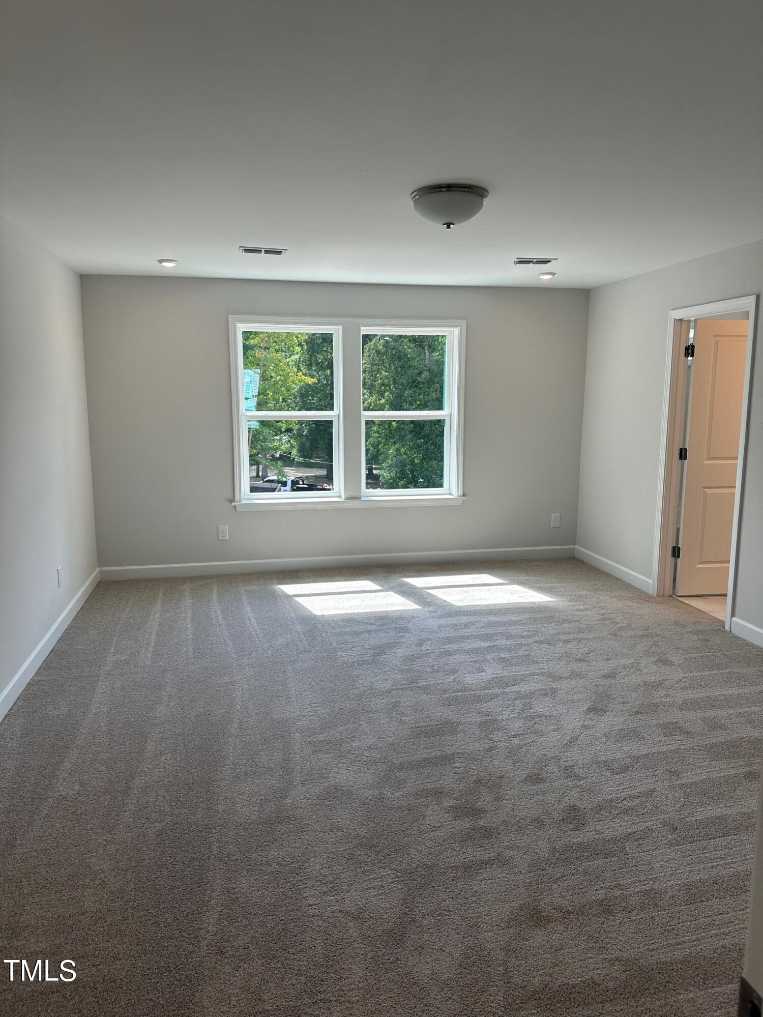 1200 Dimaggio Drive, Unit 25 Raleigh, NC 27616 - Photo 4 of 8 an empty room with windows