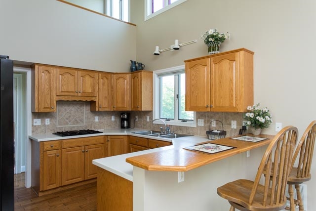 3213 Arrowhead Road Harrisonburg, VA 22801 - Photo 2 of 41 Open kitchen with gas cooktop, breakfast bar, Corian counters, and an abundance of natural light.