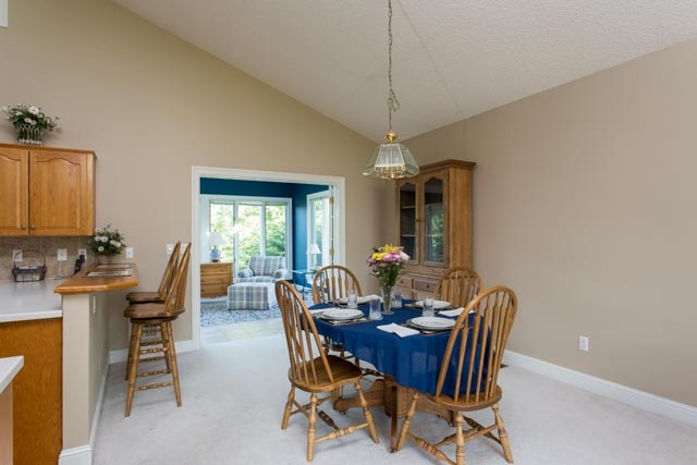 3213 Arrowhead Road Harrisonburg, VA 22801 - Photo 7 of 41 The kitchen opens up to the sunny dining area with vaulted ceiling.
