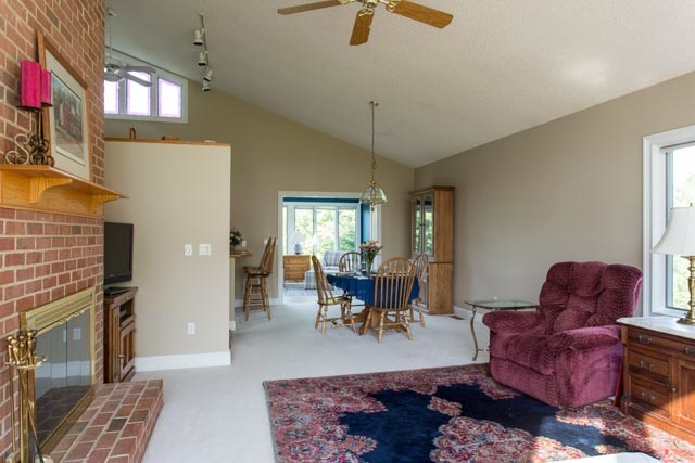 3213 Arrowhead Road Harrisonburg, VA 22801 - Photo 9 of 41 Great room with floor-to-ceiling windows and brick fireplace leads through the dining area and to the sunroom beyond.