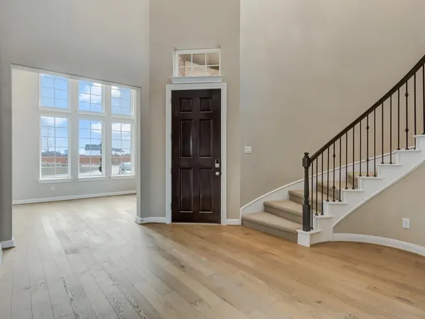 a view of entryway with wooden floor and stairs