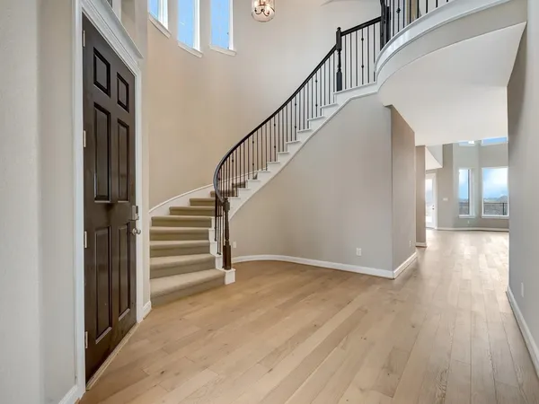 a view of entryway and hall with wooden floor