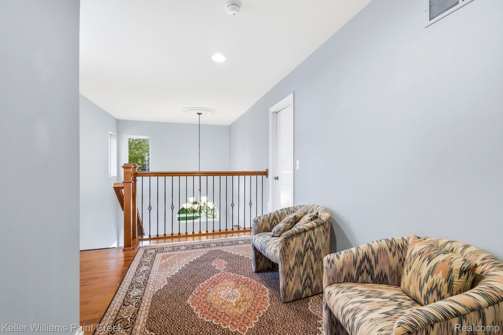 418 Oak Street Rochester, MI 48307 - Photo 27 of 38 Sitting room with wood finished floors and suspended lighting