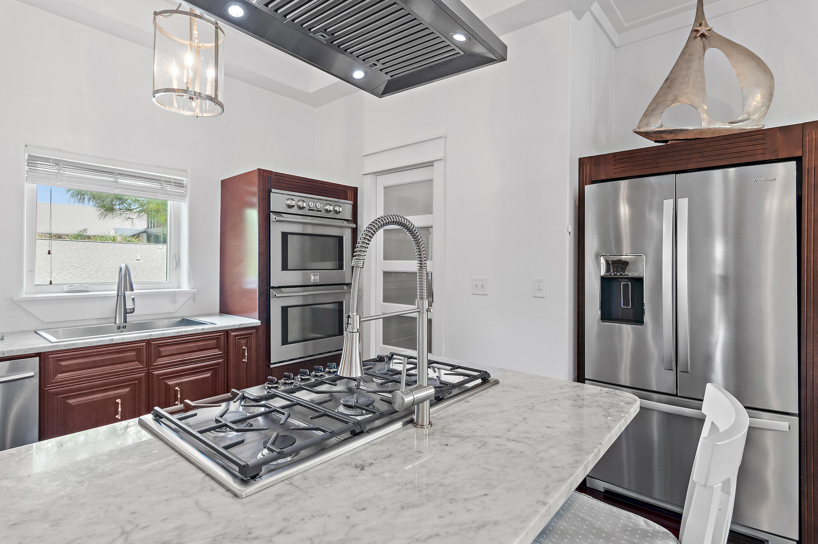 96 Hilltop Drive Santa Rosa Beach, FL 32459 - Photo 10 of 50 a kitchen with stainless steel appliances granite countertop a refrigerator a stove and a sink with wooden floor