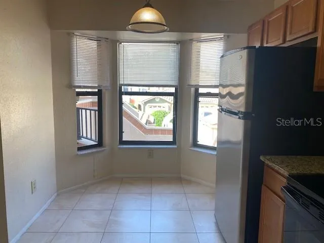 a kitchen with windows and refrigerator