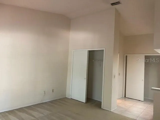 an empty room with closet area