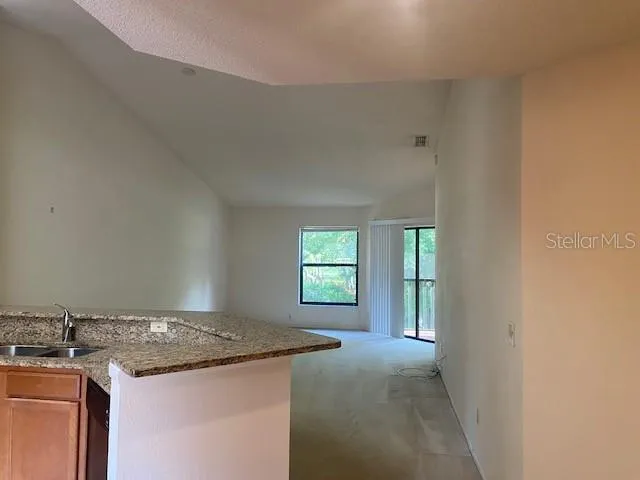 a kitchen with a stove and a window