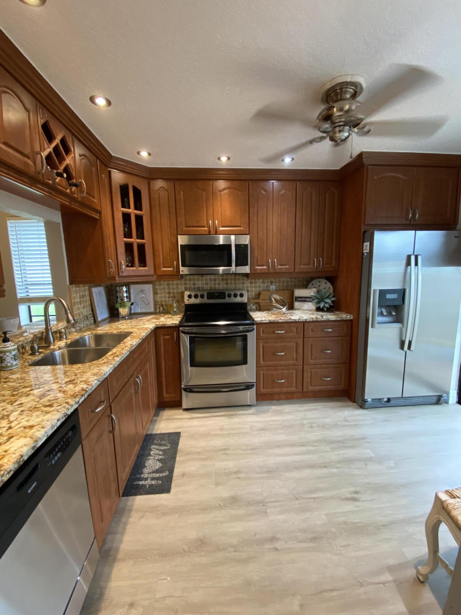 595 Banks Road Margate, FL 33063 - Photo 14 of 35 a kitchen with stainless steel appliances a sink and a microwave