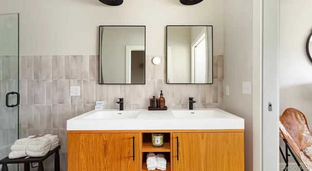 a bathroom with a granite countertop sink and a mirror