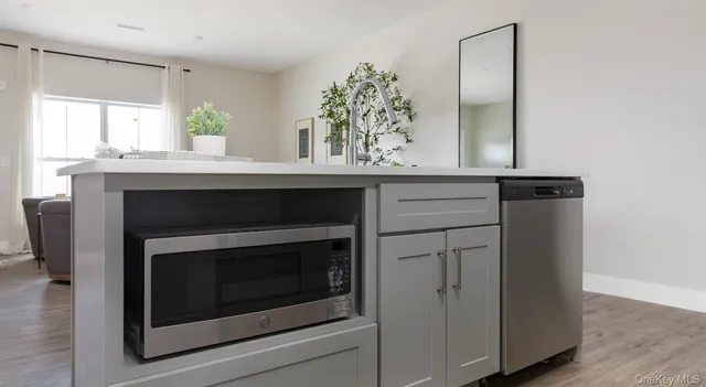 a kitchen with a fireplace and a window