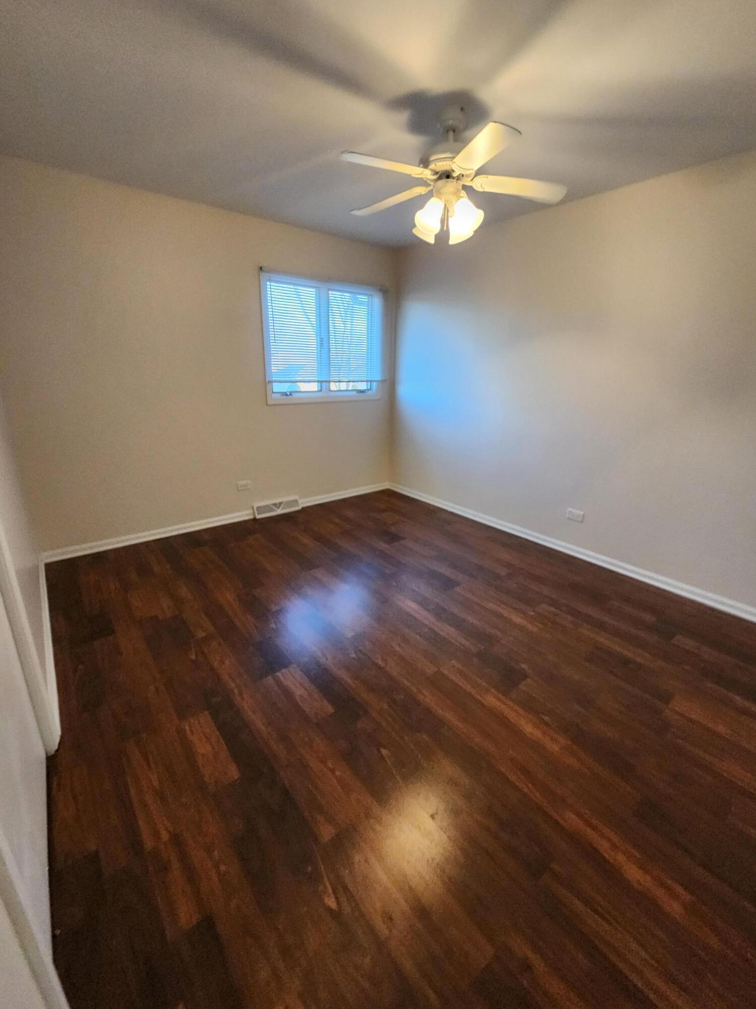 2308 Flint Court Dyer, IN 46311 - Photo 19 of 37 a view of an empty room with wooden floor and a window