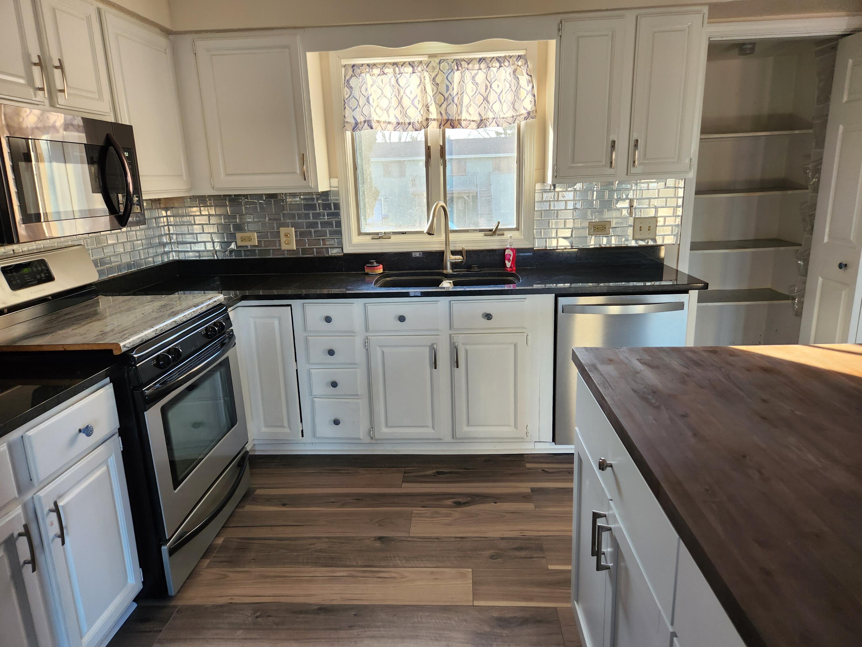 2308 Flint Court Dyer, IN 46311 - Photo 7 of 37 a kitchen with granite countertop a sink a stove and cabinets