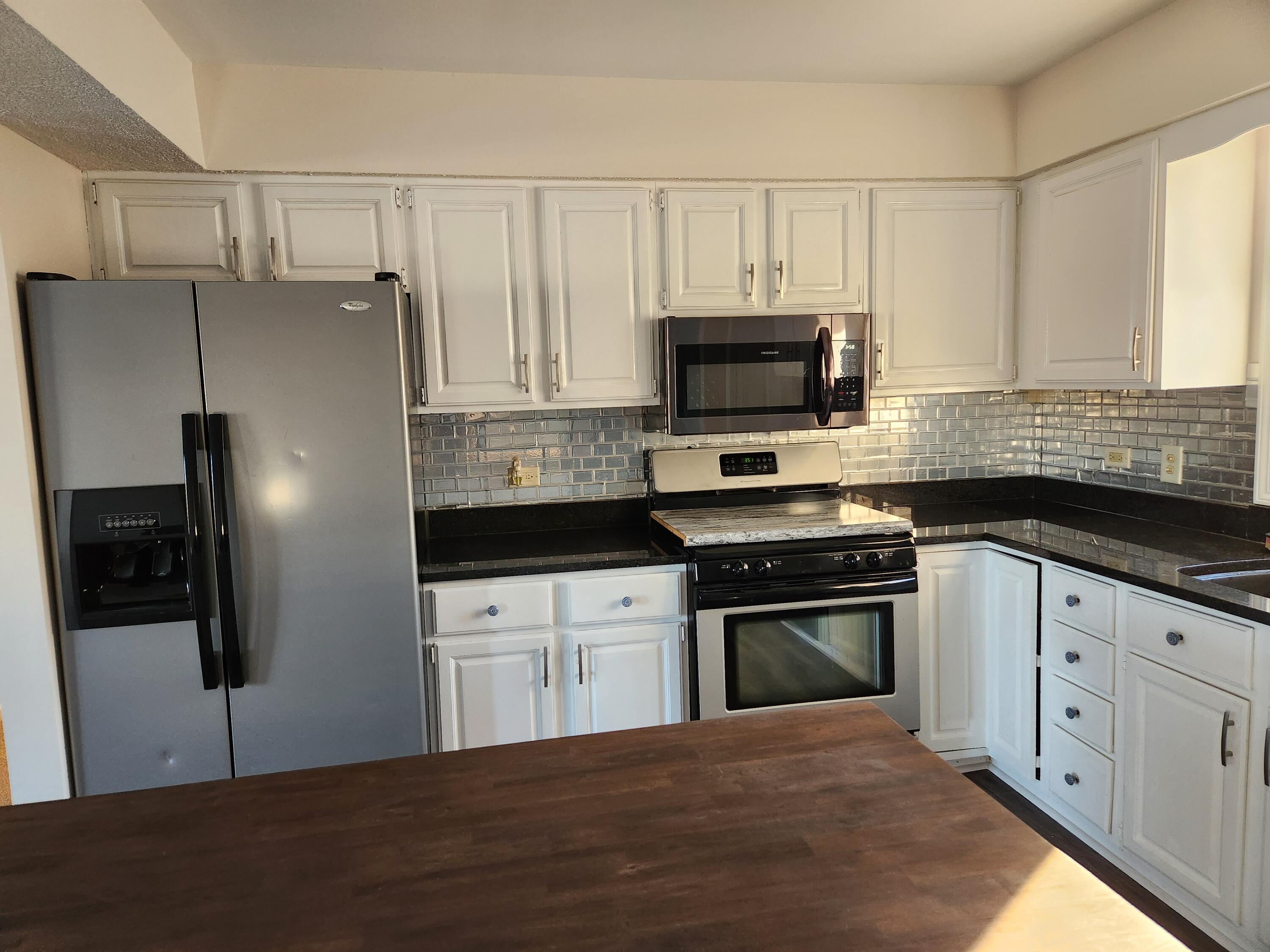 2308 Flint Court Dyer, IN 46311 - Photo 8 of 37 a kitchen with granite countertop a refrigerator stove and microwave