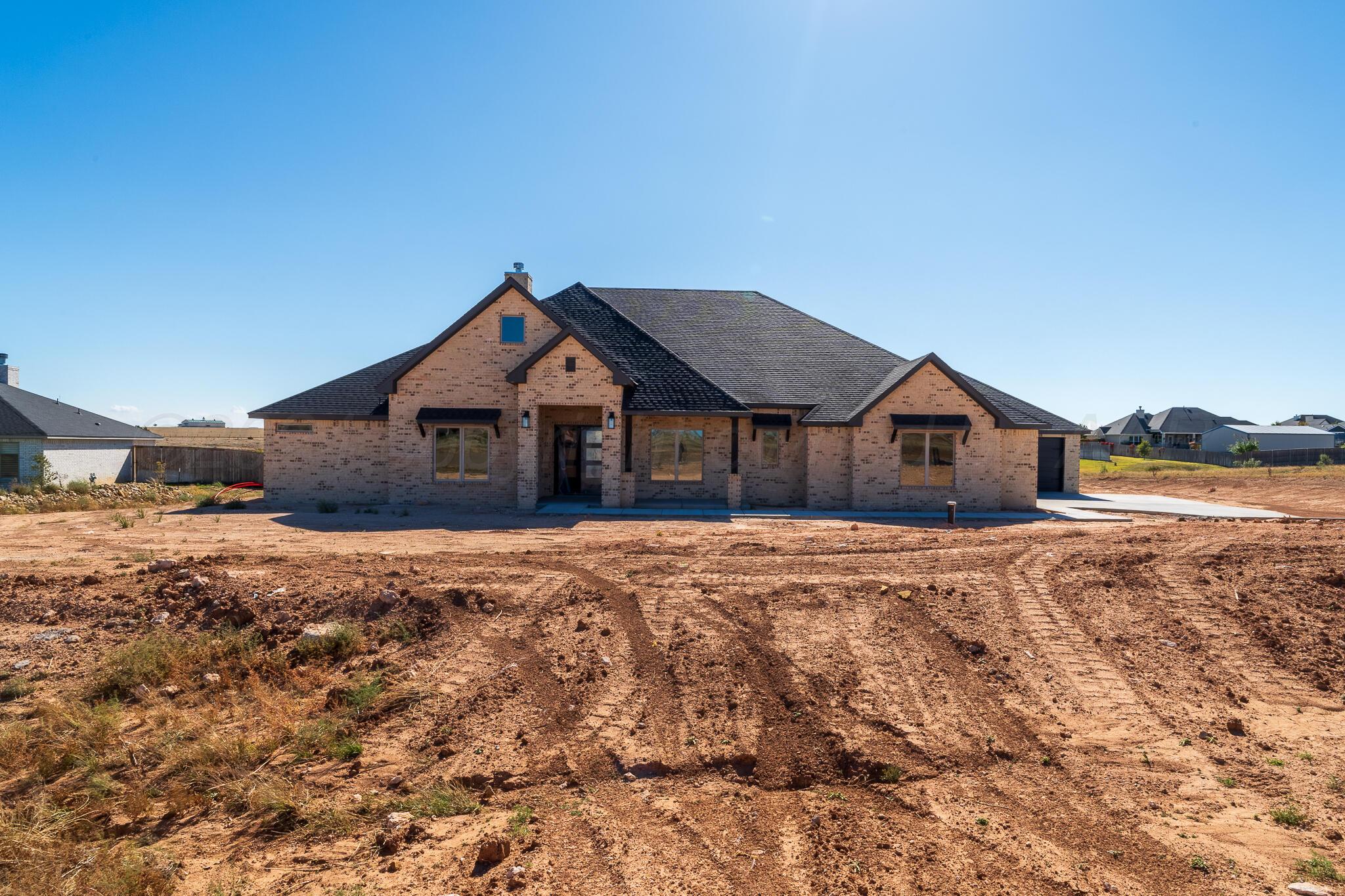 19401 Falling Rock Road Amarillo, TX 79124 - Photo 2 of 5 a wooden house with a yard and wooden fence