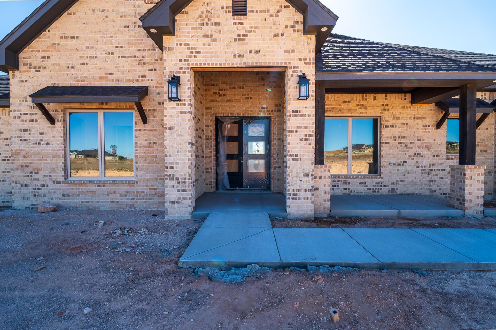 19401 Falling Rock Road Amarillo, TX 79124 - Photo 3 of 5 a front view of a house with garden