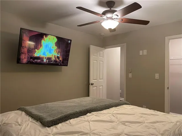 a bedroom with a bed and a painting on the wall