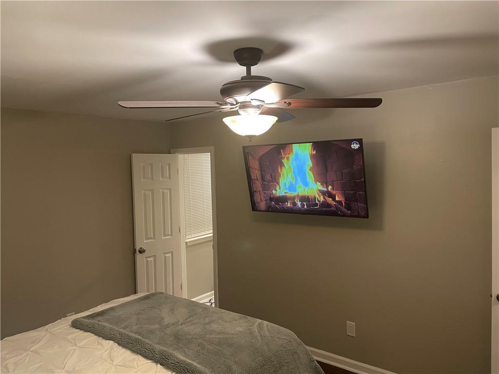 357 Waits Drive Southwest, Unit 1 Atlanta, GA 30331 - Photo 4 of 8 a bedroom with a bed and a chandelier