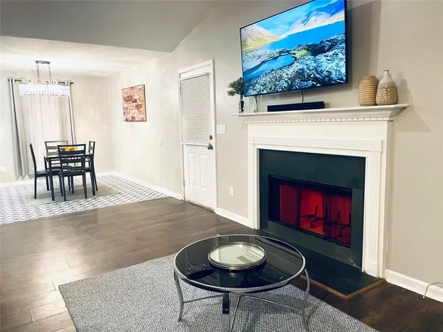 a living room with furniture a rug and a fireplace