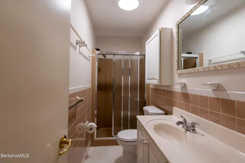 a bathroom with a sink toilet and shower