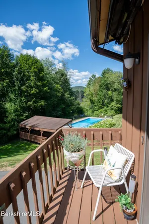 a view of balcony with wooden floor and outdoor seating