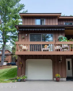 a view of building with car parked