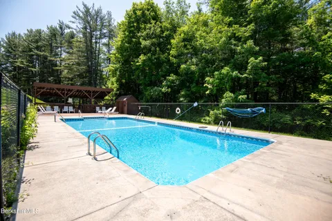 a view of swimming pool with chairs