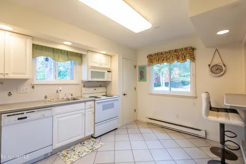 a spacious bathroom with a mirror a sink and a window