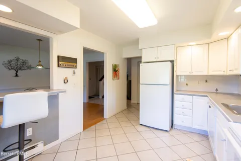 a kitchen with a refrigerator sink and cabinets