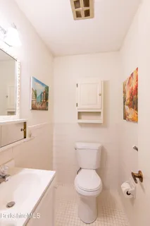 a white toilet sitting next to a bathroom sink