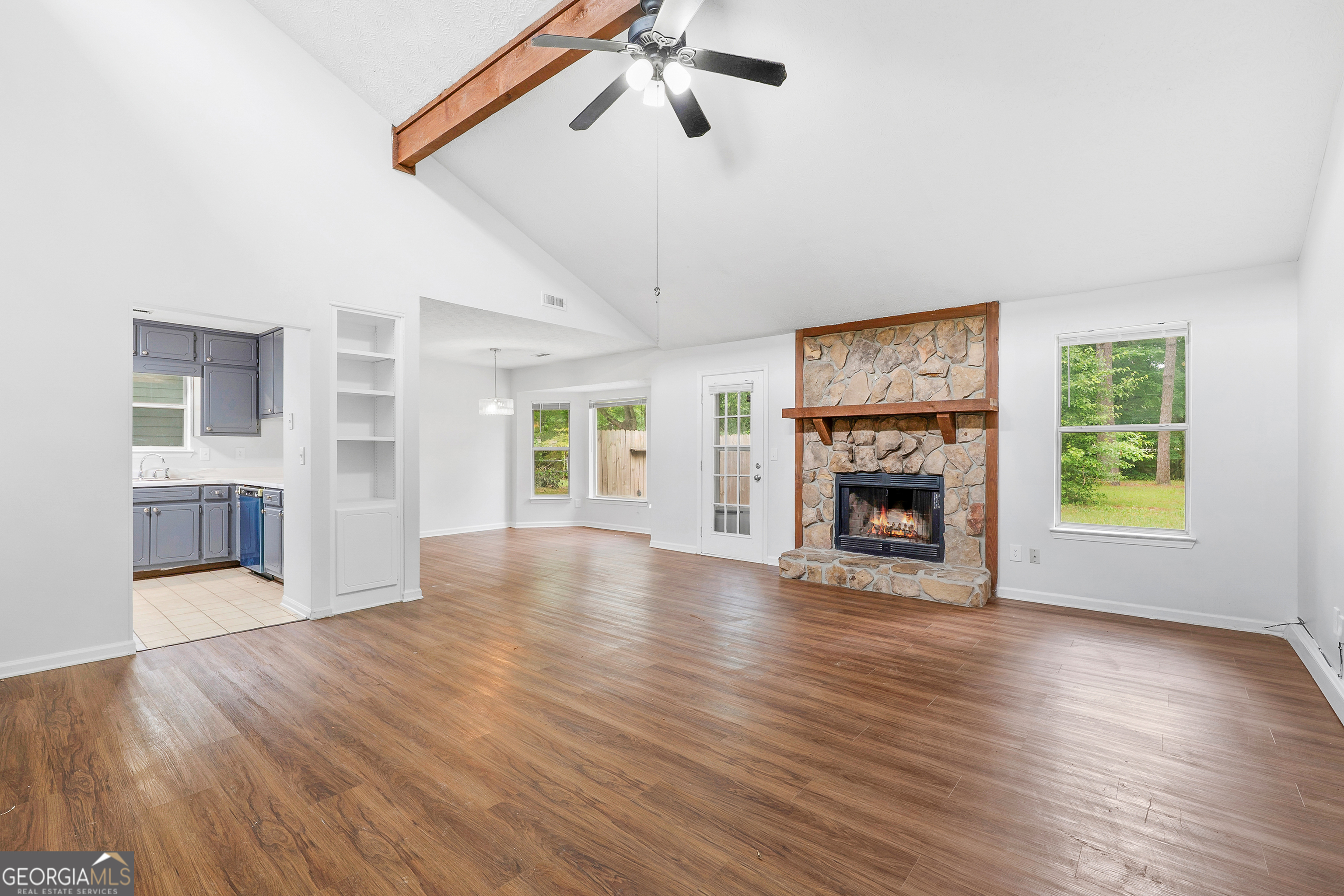 1328 Foxvale Drive Hampton, GA 30228 - Photo 7 of 27 wooden floor fireplace and windows in an empty room