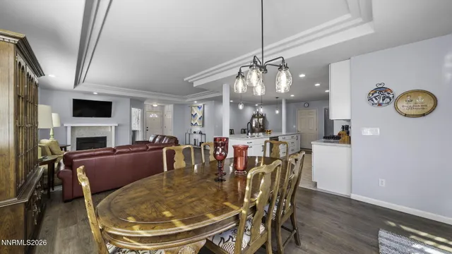 a view of a dining room with furniture and a chandelier