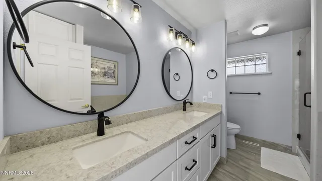 a bathroom with a granite countertop sink mirror and vanity