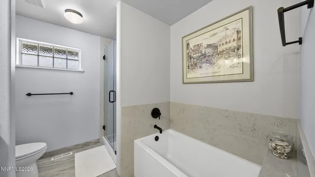 a bathroom with a bathtub and a toilet