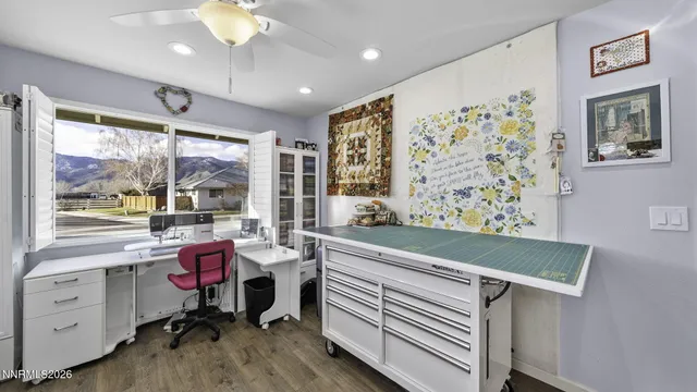 a view of a workspace with furniture and a window