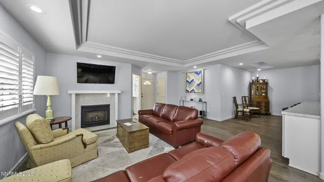 a living room with furniture a flat screen tv and a fireplace
