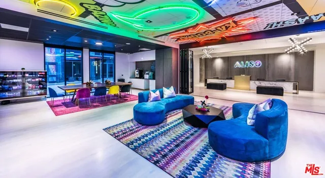 a living room with furniture a rug and a chandelier