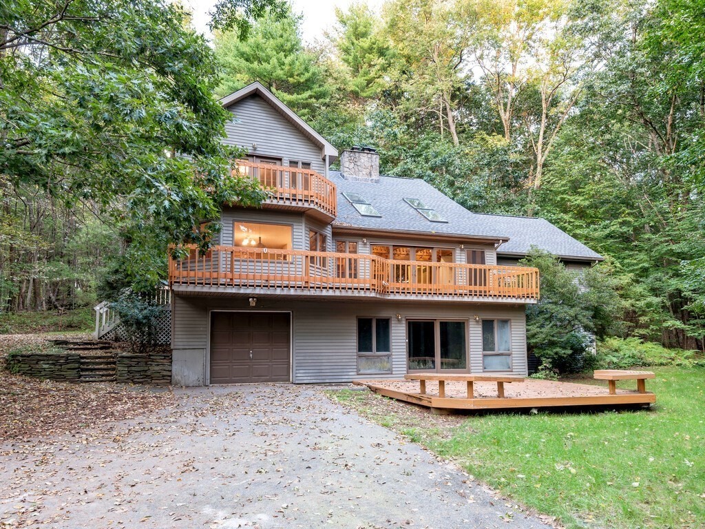 49 Denfield Road Charlton, MA 01507 - Photo 1 of 42 a front view of a house with a garden and trees