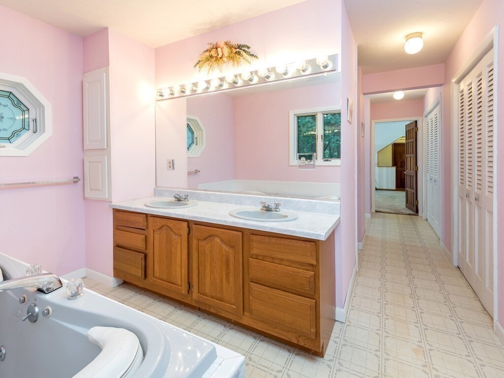 49 Denfield Road Charlton, MA 01507 - Photo 26 of 42 a bathroom with a tub sink and mirror