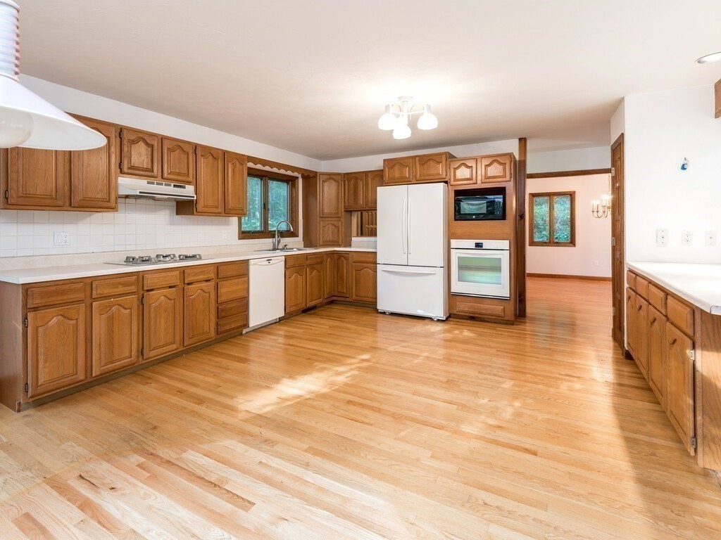 49 Denfield Road Charlton, MA 01507 - Photo 4 of 42 a large kitchen with stainless steel appliances wooden cabinets and a counter top space