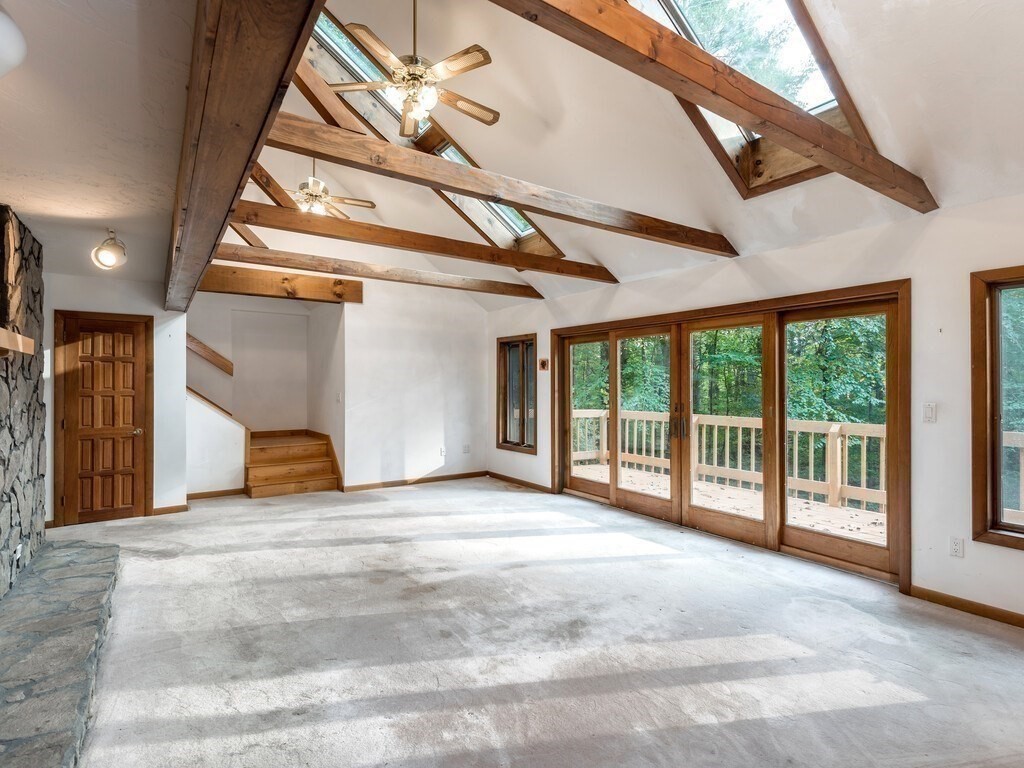 49 Denfield Road Charlton, MA 01507 - Photo 8 of 42 a view of an empty room with a balcony