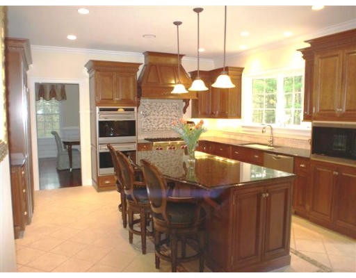 125 Conant Road Weston, MA 02493 - Photo 3 of 16 a kitchen with stainless steel appliances kitchen island granite countertop a sink and cabinets