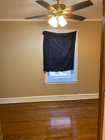 a kitchen with granite countertop a stove a sink and a white cabinets